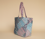 Close-up of Ahir embroidery floral stitching detail on pink tote