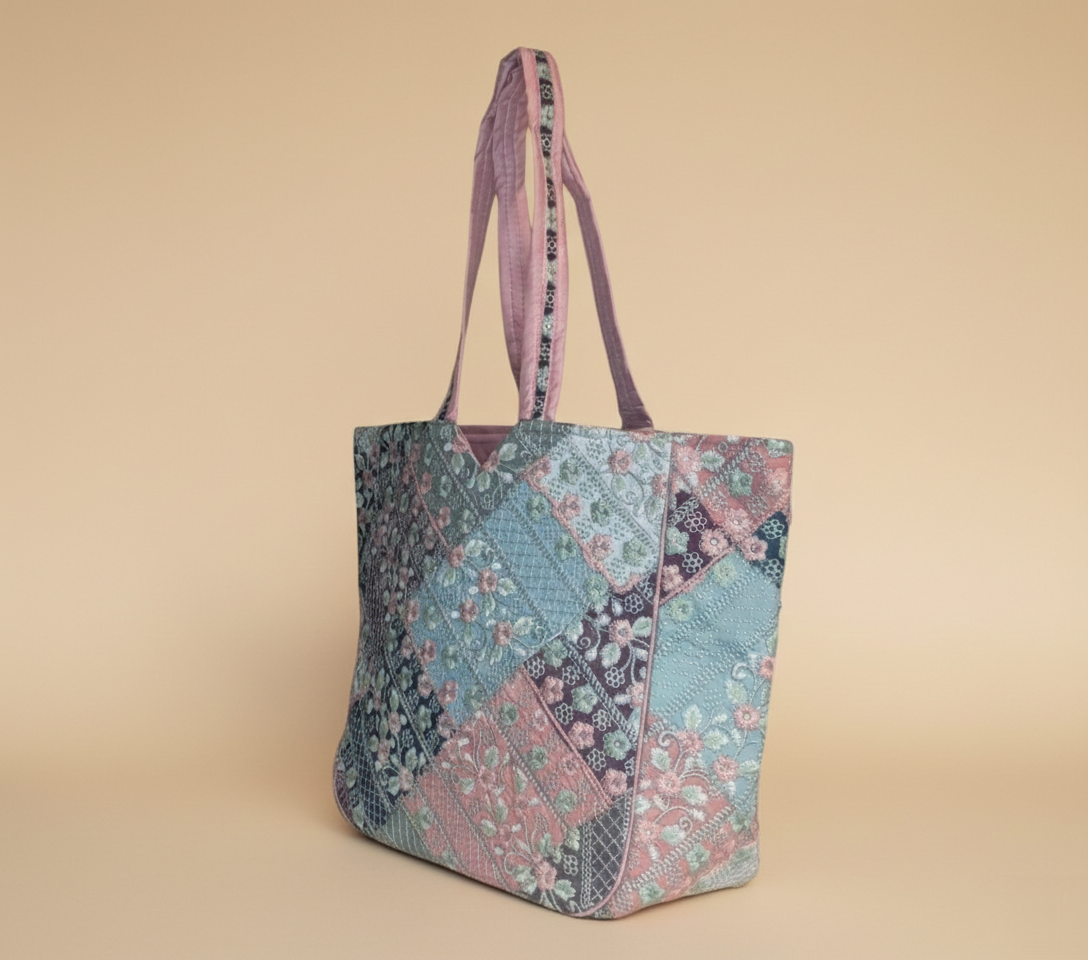 Close-up of Ahir embroidery floral stitching detail on pink tote
