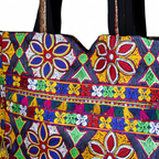 Model walking with Jat Mutava rangoli Suf tote bag — lifestyle shot