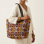Model walking with Jat Mutava yellow red diamond Suf tote bag — lifestyle shot