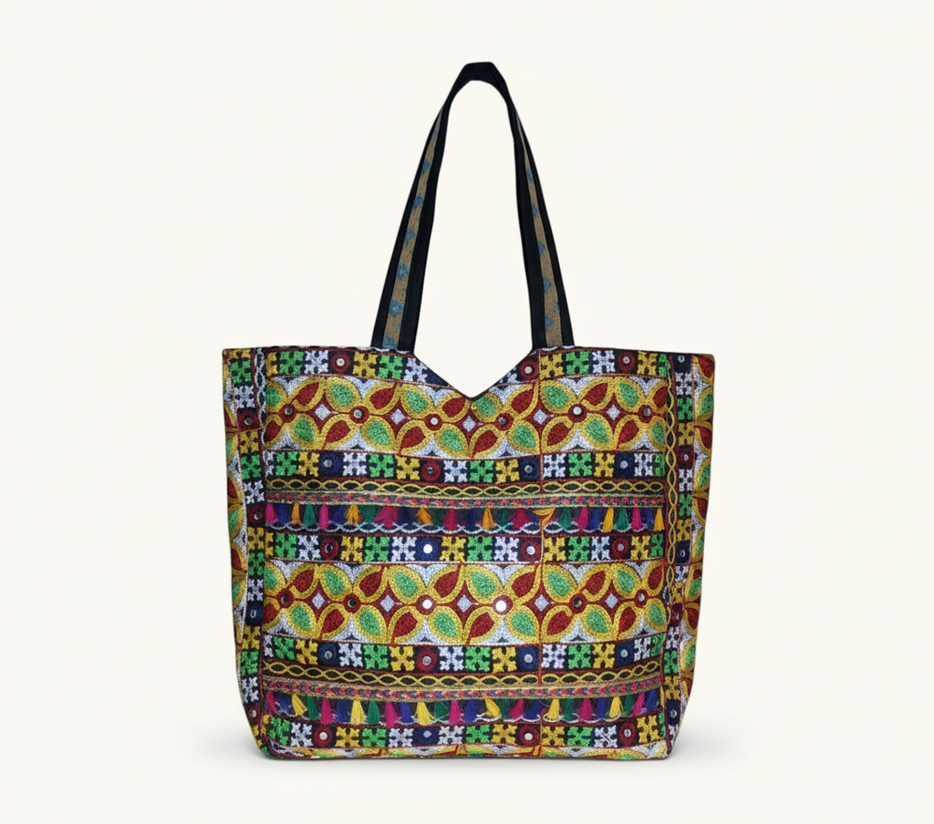 Model walking with Jat Mutava red yellow leaf Suf tote bag — lifestyle shot