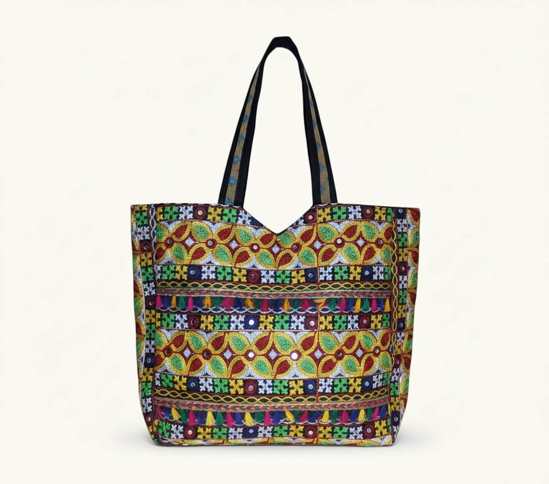 Model walking with Jat Mutava red yellow leaf Suf tote bag — lifestyle shot