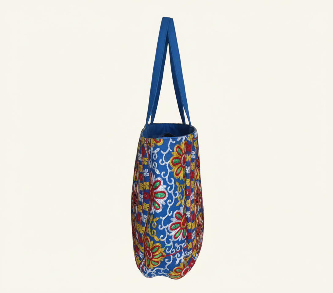 Model carrying Rabari embroidery blue elephant tote bag — boho style