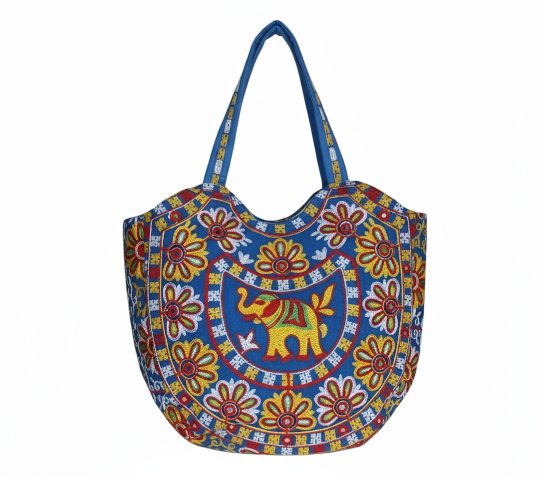 Model walking with Rabari embroidery blue elephant tote bag — lifestyle shot