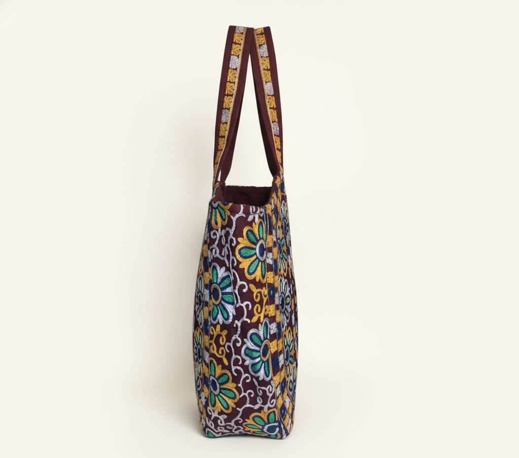 Model carrying Rabari embroidery maroon elephant tote bag — boho style