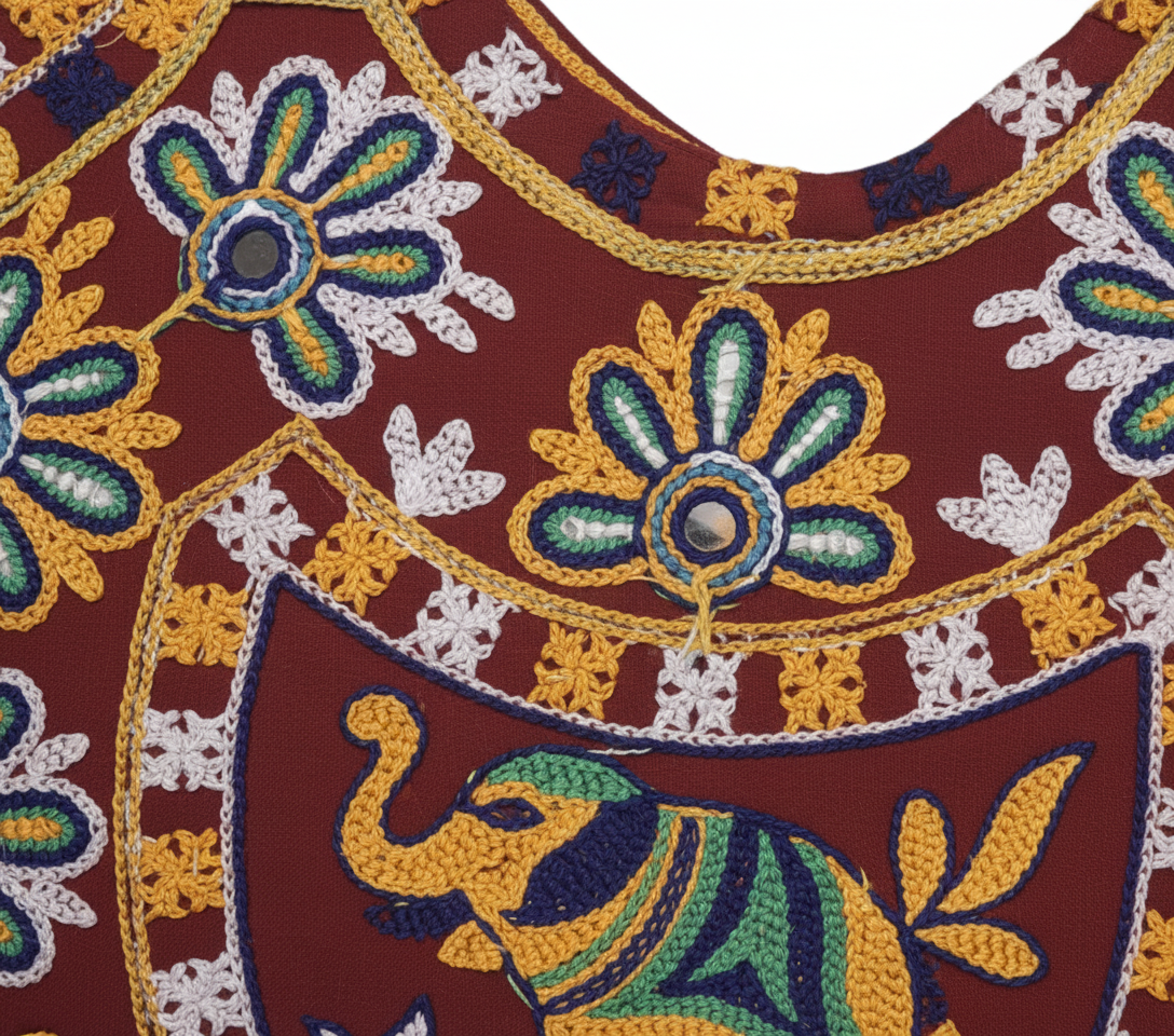 Model carrying Rabari embroidery red elephant yellow accent tote bag — boho style