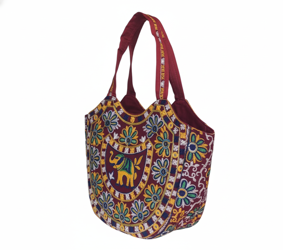 Model carrying Rabari embroidery red elephant tote bag — boho style