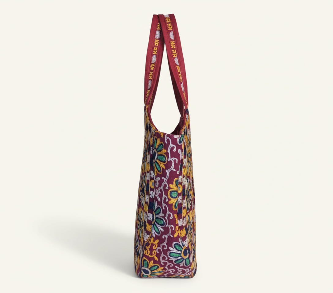 Model walking with Rabari embroidery red elephant tote bag — lifestyle shot