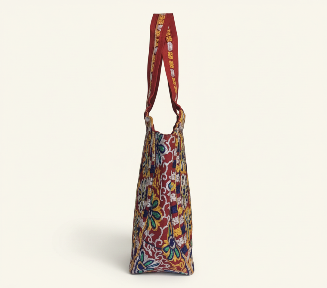 Model walking with Rabari embroidery red peacock tote bag — lifestyle shot