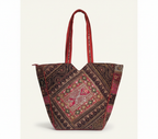 Model carrying Gotta Patch Crimson Shimmer tote bag — boho style
