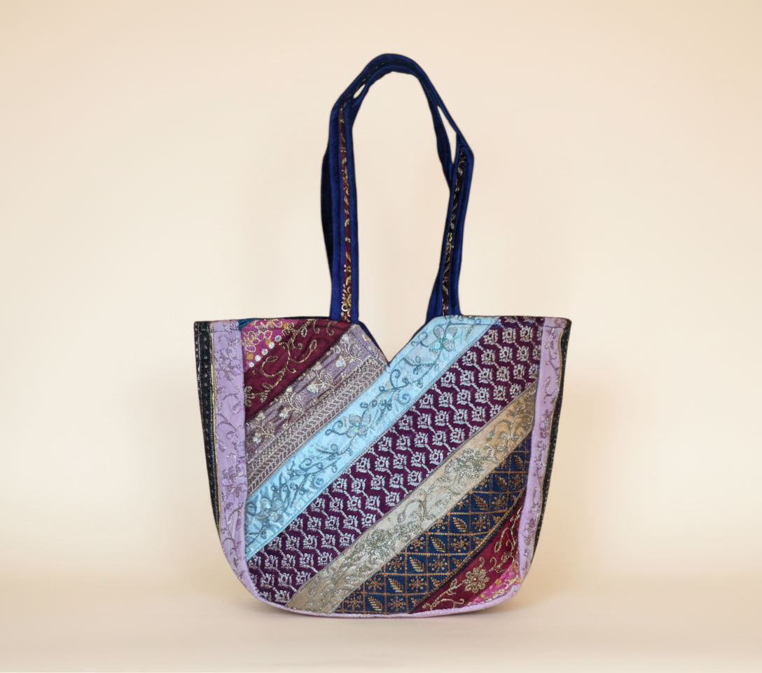 Close-up of Indigo Radiance gotta patti mirror and tassel detail on tote bag