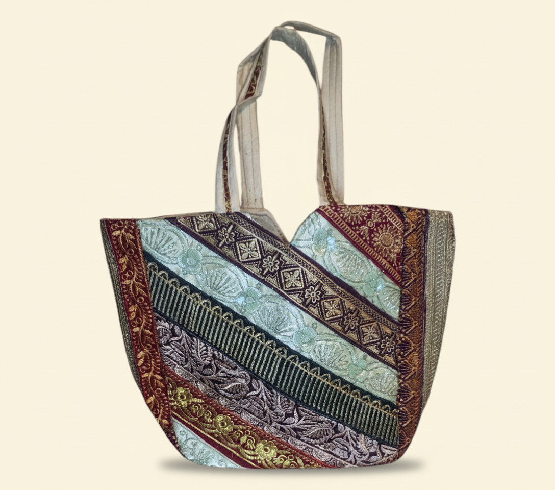 Close-up of Pearl Radiance gotta patti mirror and tassel detail on tote bag