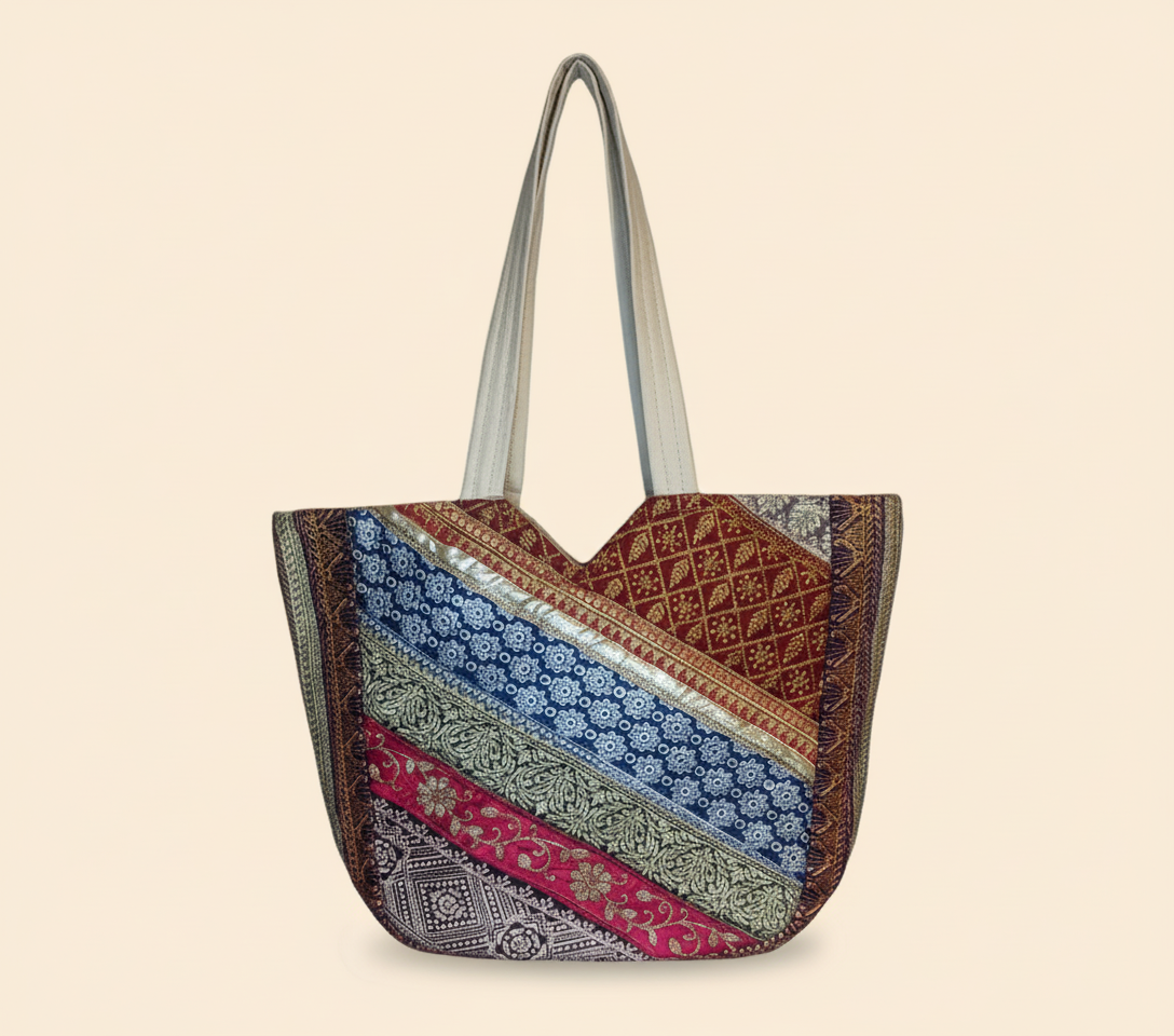 Close-up of Ivory Gleam gotta patti mirror and tassel detail on tote bag