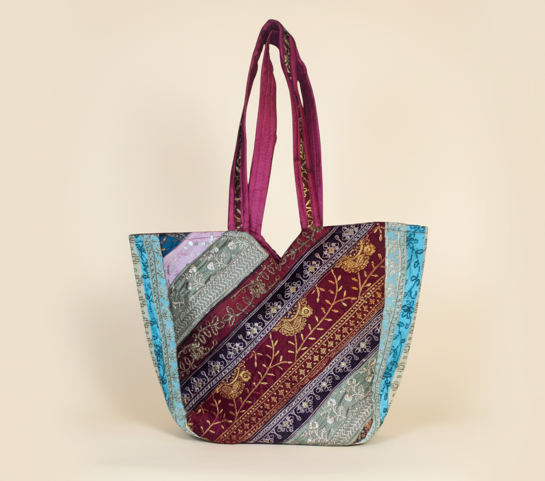 Close-up of Blush Radiance gotta patti mirror and tassel detail on tote bag