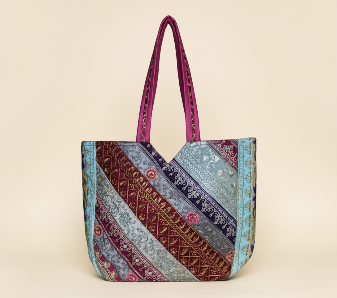 Close-up of Rose Gleam gotta patti mirror and tassel detail on tote bag
