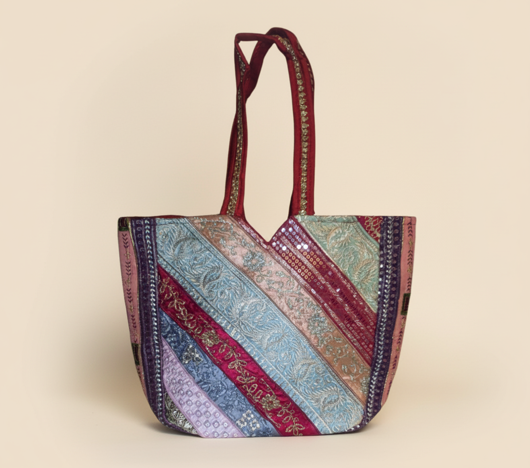Model carrying Gotta Patti Mirror Tassel Crimson Radiance tote bag — boho style