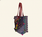 Close-up of Ruby Radiance gotta patti mirror and tassel detail on tote bag