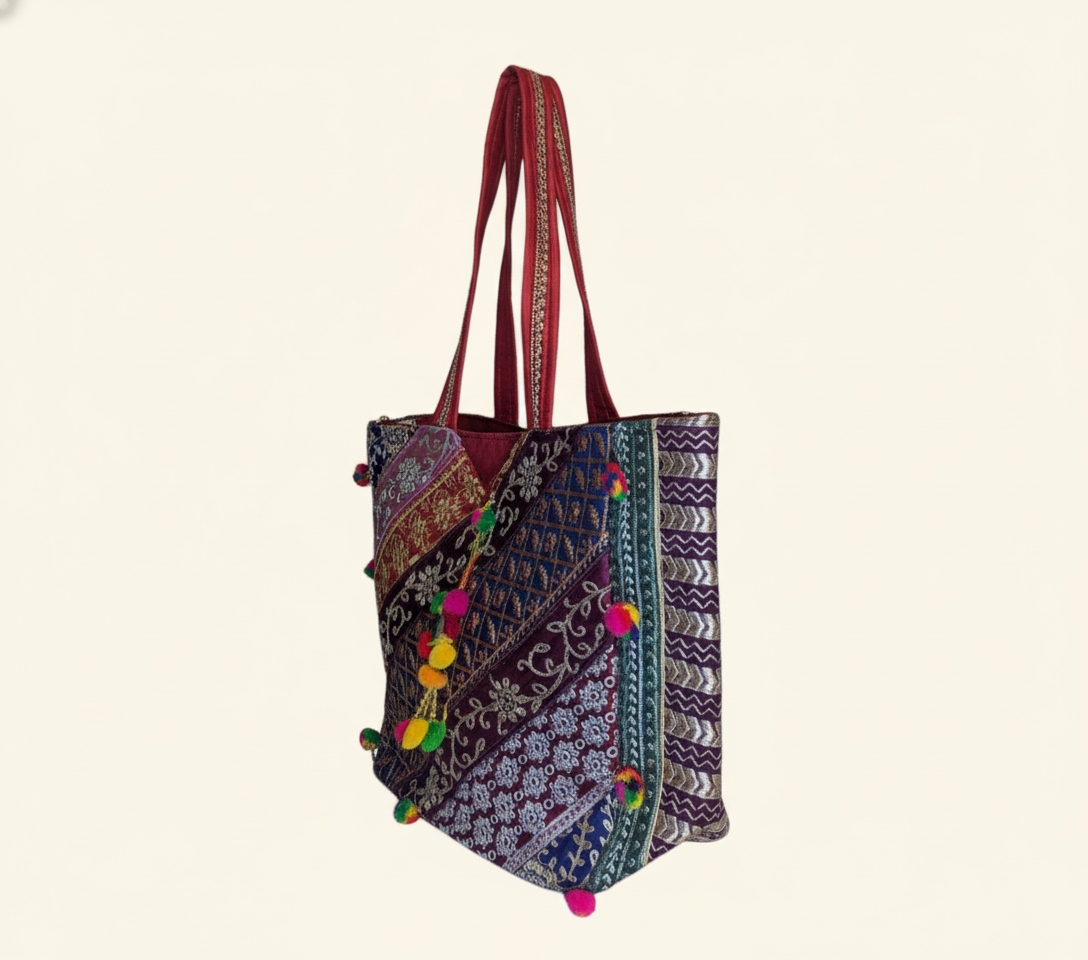 Close-up of Ruby Radiance gotta patti mirror and tassel detail on tote bag