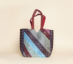 Model carrying Gotta Patti Mirror Tassel Ruby Radiance tote bag — boho style