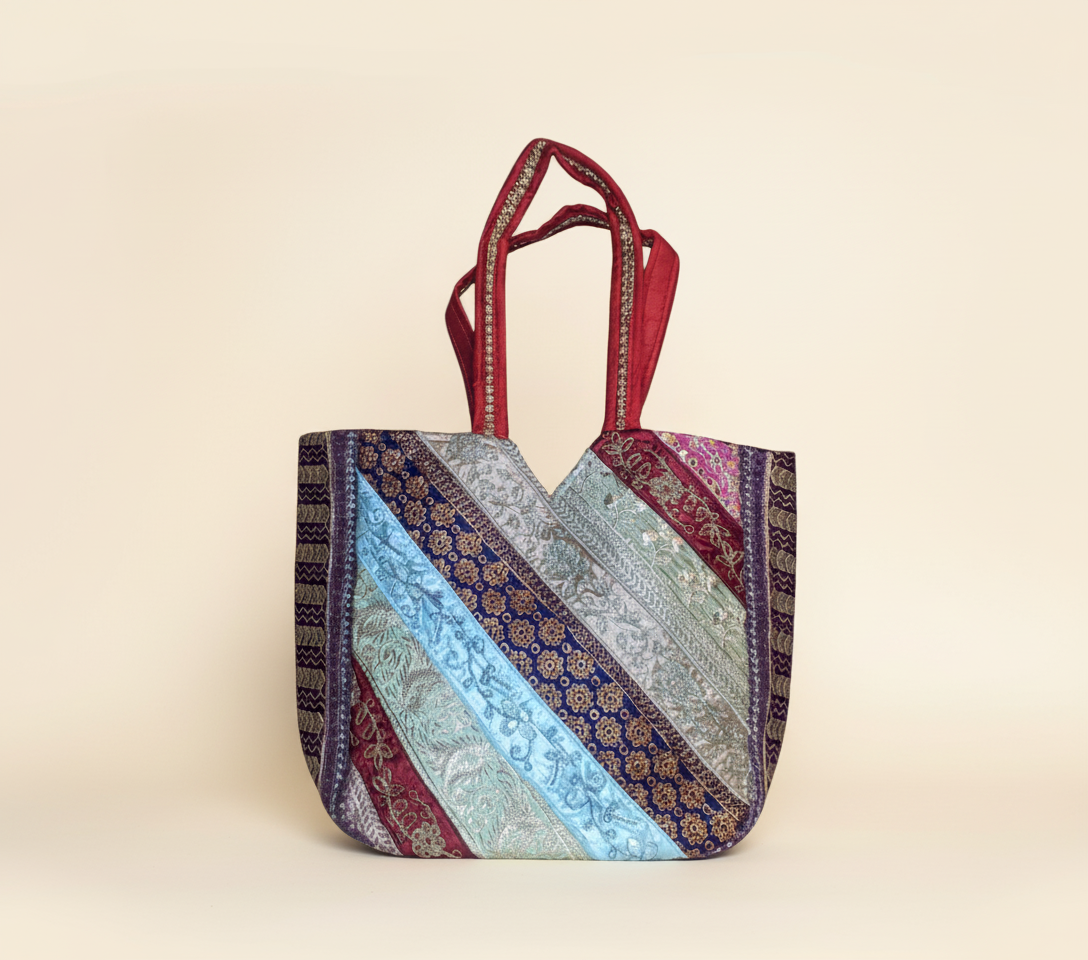 Model carrying Gotta Patti Mirror Tassel Ruby Radiance tote bag — boho style