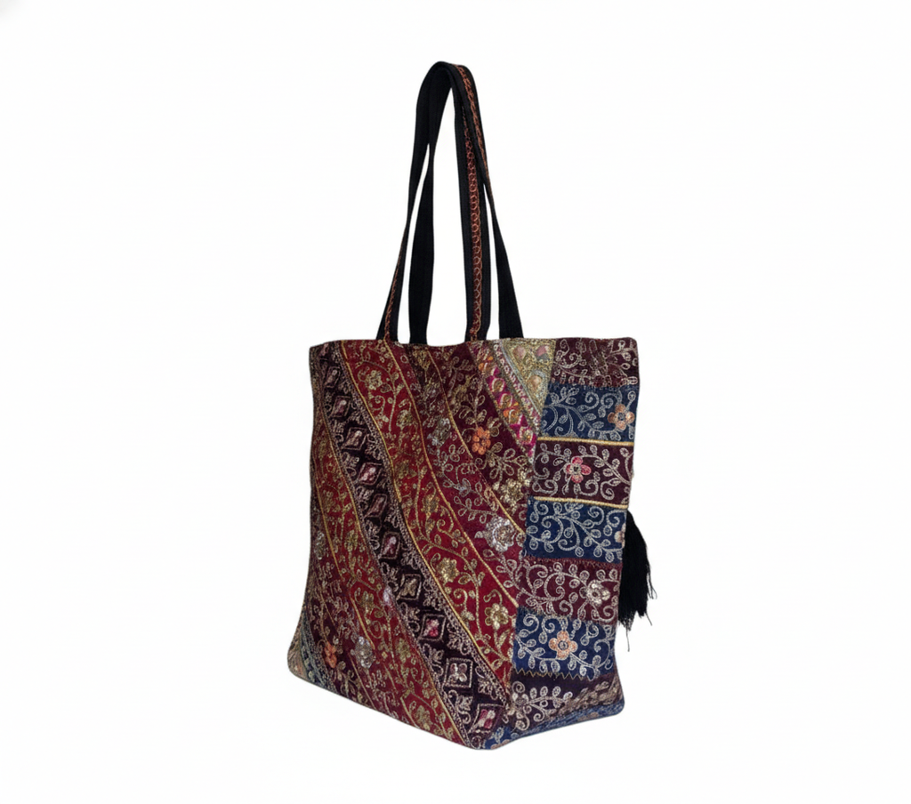 Model carrying Gotta Patti Shell Tassel Crimson Festival tote bag — boho style