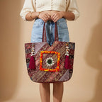 Model carrying Gotta Patti Shell Tassel Wine Festival tote bag — boho style