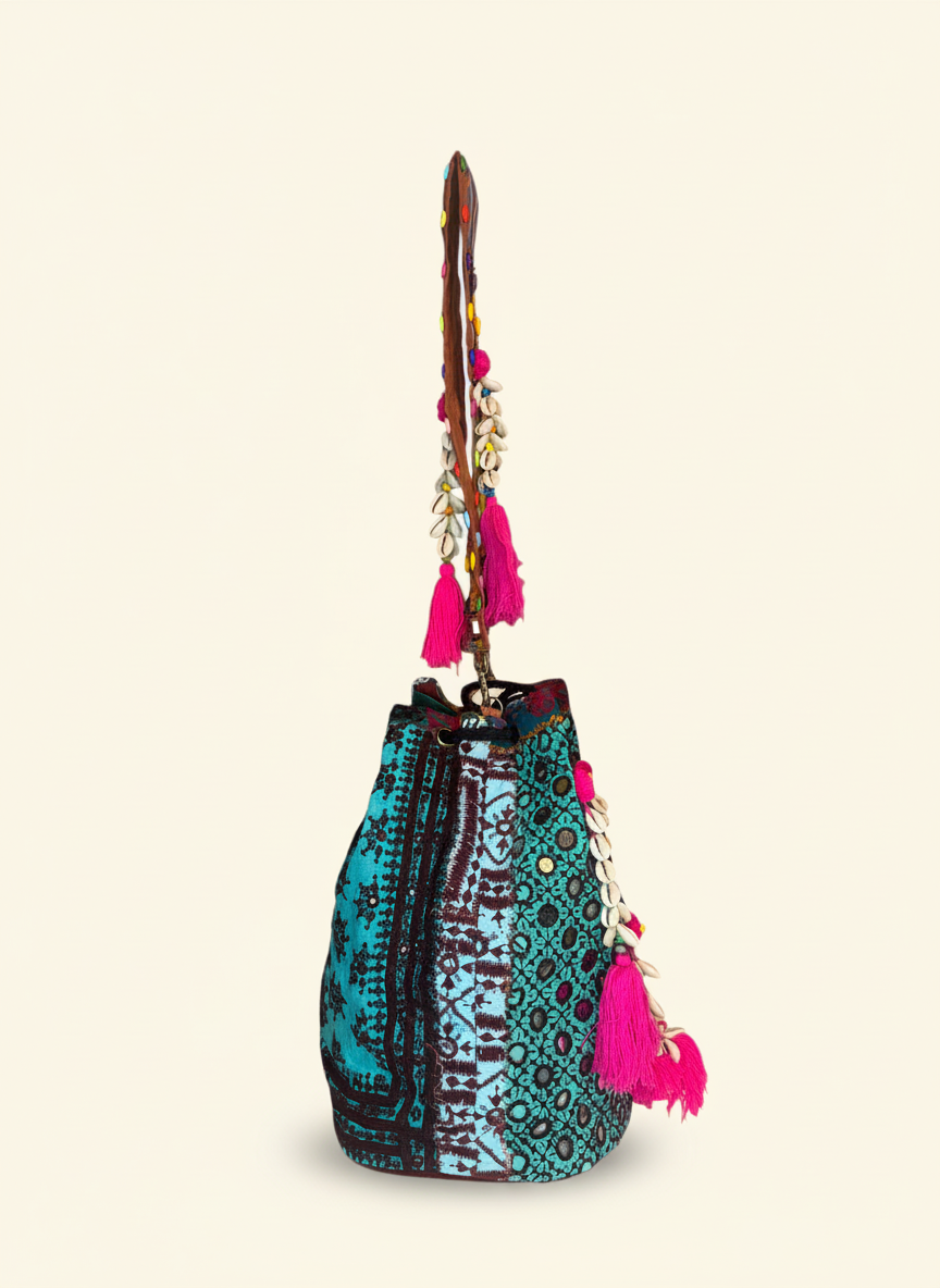 Close-up of Lagoon Bloom cowrie shell & tassel detail