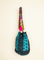Model carrying Shell Tassel Lagoon Bloom (Large) bucket bag — boho style