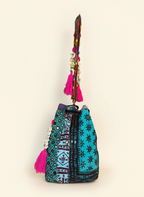 Model walking with Shell Tassel Lagoon Bloom (Large) bucket bag — lifestyle shot