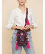 Model walking with Shell Tassel Indigo Dahlia (Medium) bucket bag — lifestyle shot