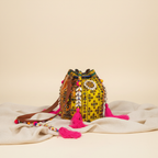 Model walking with Shell Tassel Citrus Bloom (Medium) bucket bag — lifestyle shot