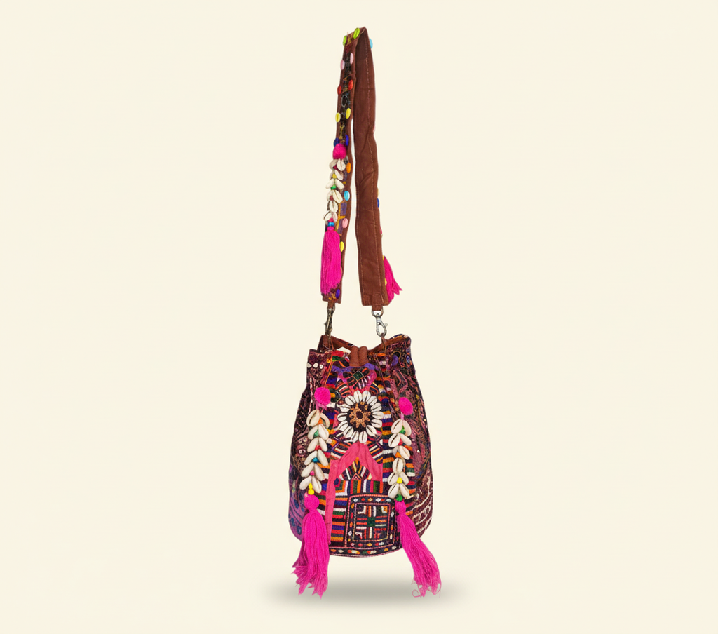 Model carrying Shell Tassel Garnet Arch (Medium) bucket bag — boho style