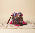 Model walking with Shell Tassel Lilac Prism (Medium) bucket bag — lifestyle shot