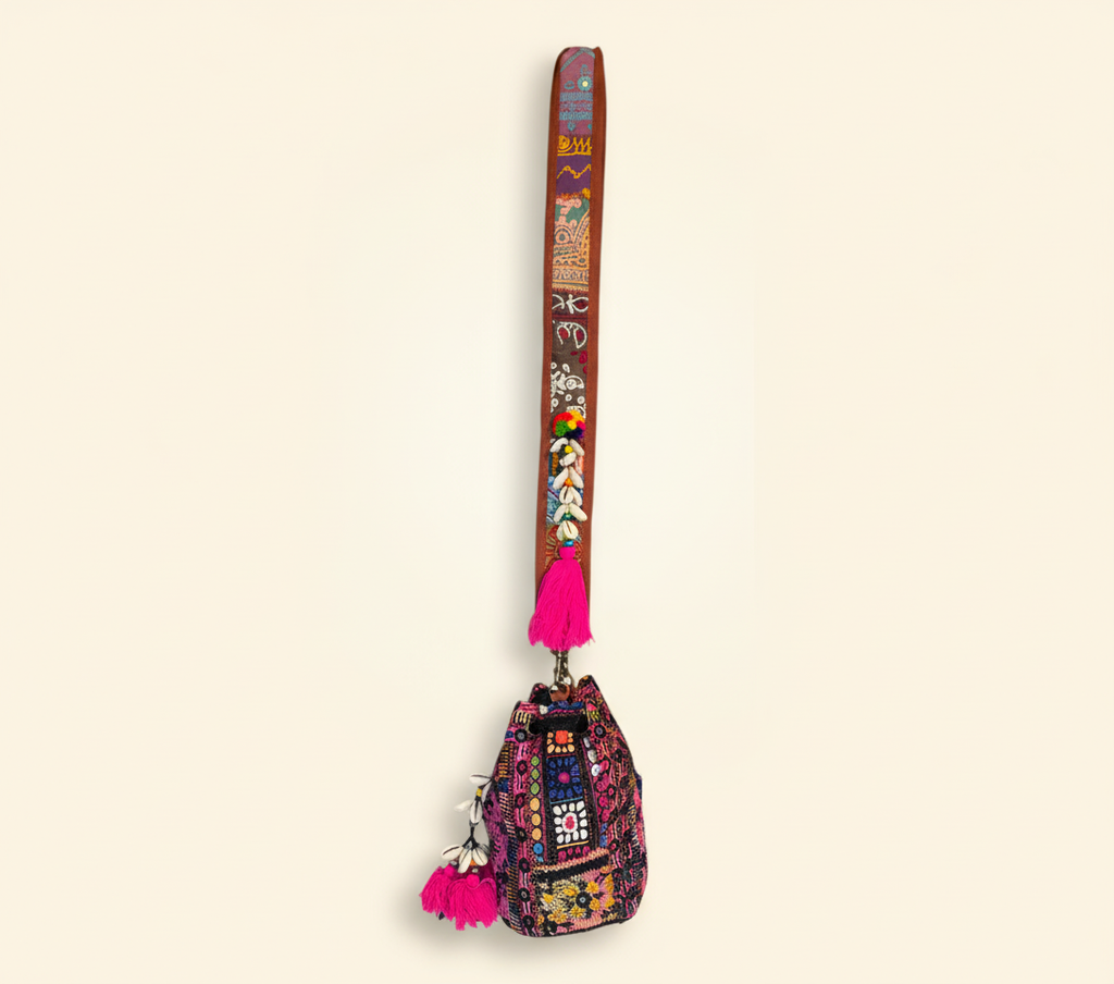 Close-up of Fuchsia Spark cowrie shell & tassel detail