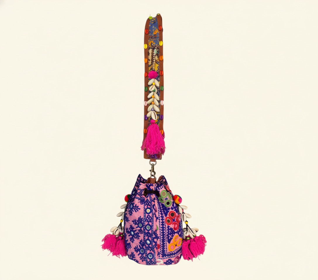 Close-up of Indigo Ring cowrie shell & tassel detail