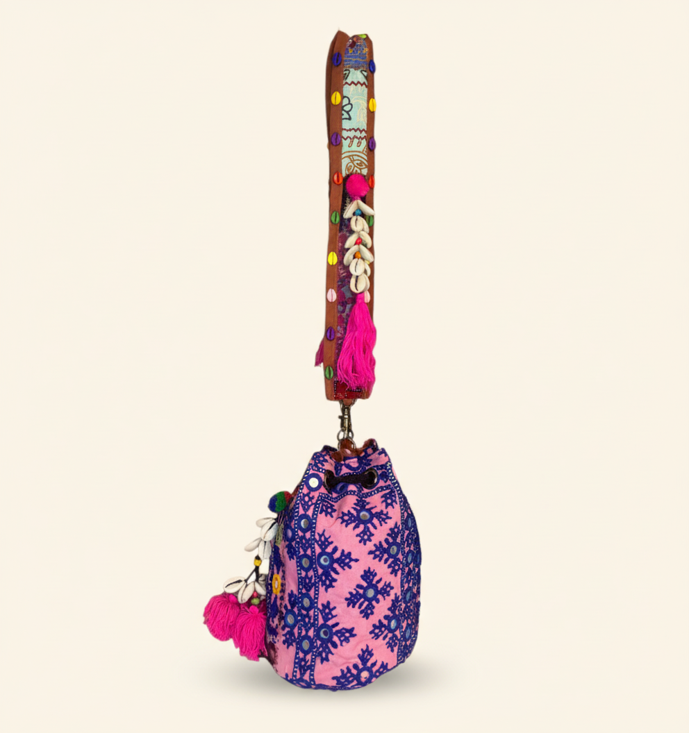 Model walking with Shell Tassel Indigo Ring (Mini) bucket bag — lifestyle shot