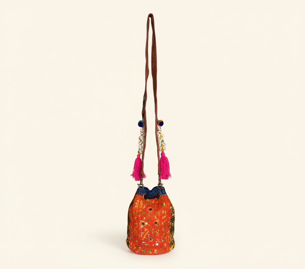 Close-up of Tangerine Spark cowrie shell & tassel detail