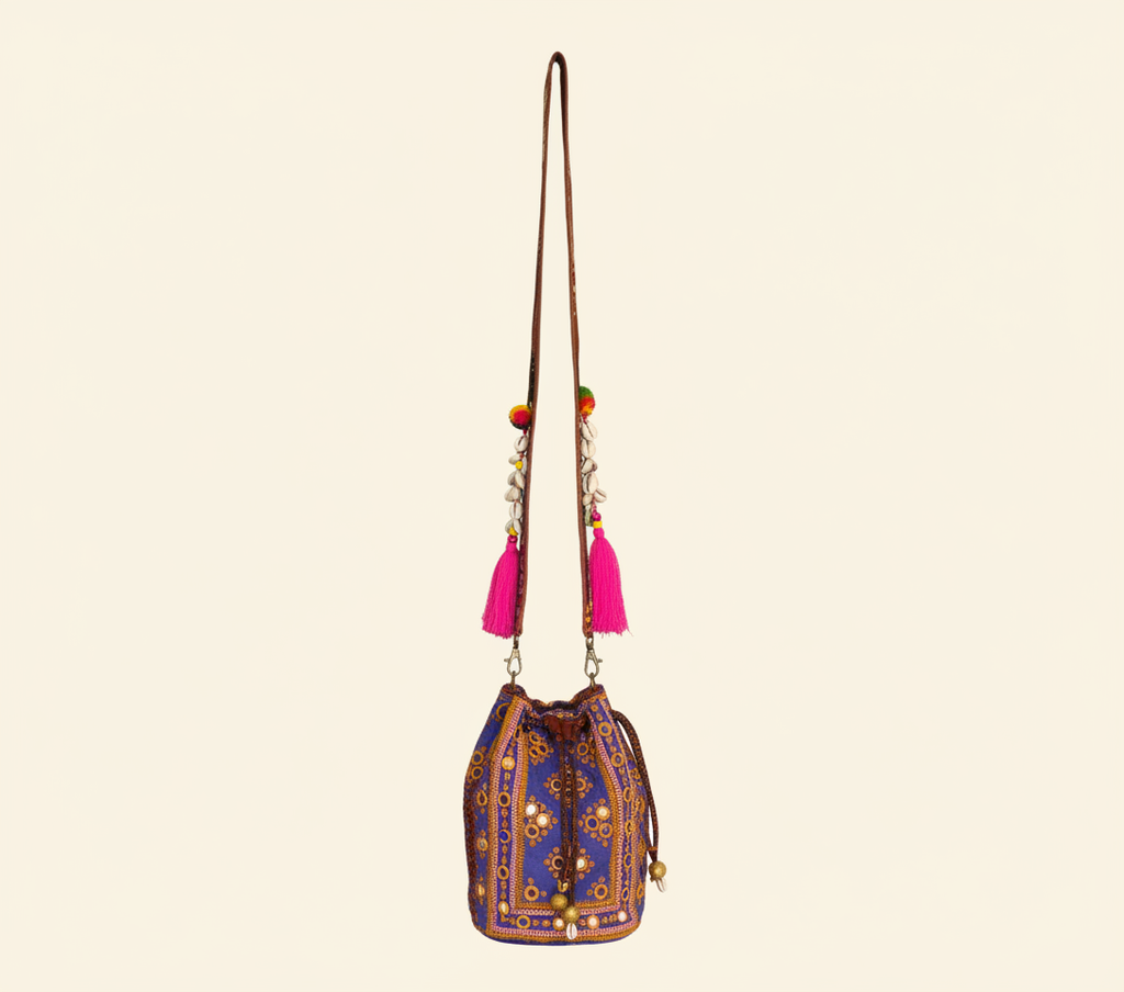 Close-up of Violet Aura cowrie shell & tassel detail