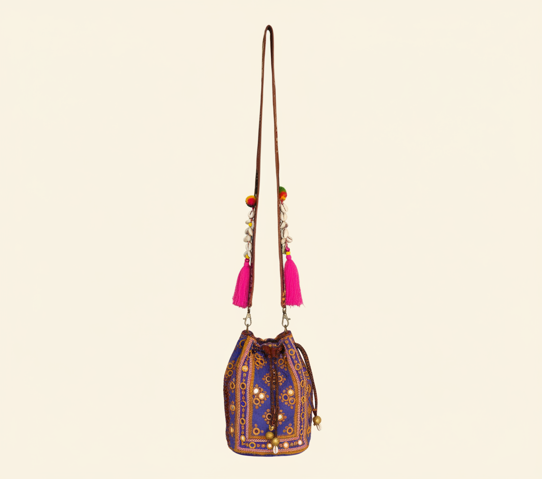 Close-up of Violet Aura cowrie shell & tassel detail