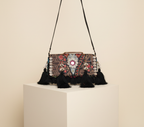Model walking with Shell Tassel Ratrani crossbody bag — lifestyle shot