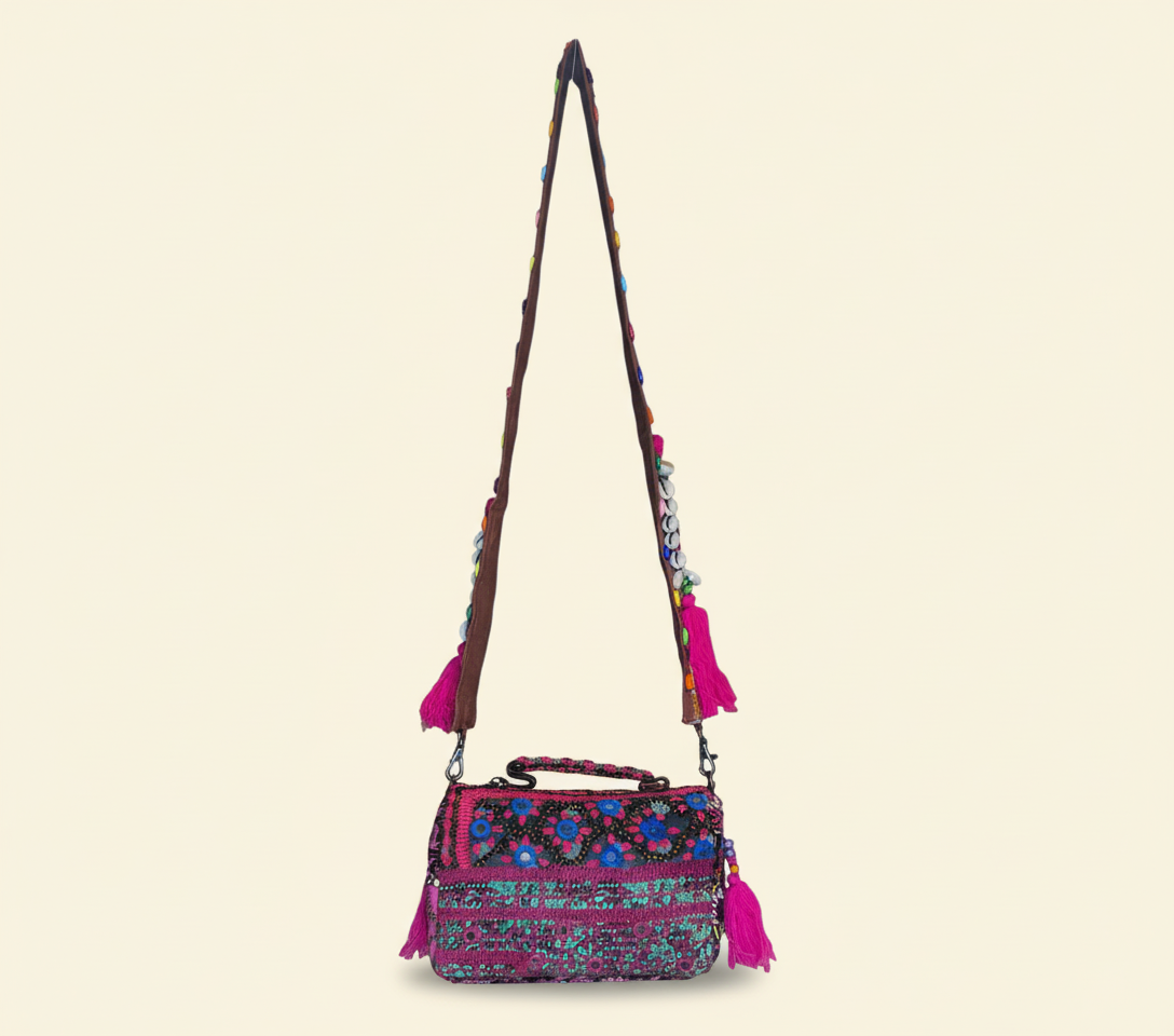 Model carrying Shell Tassel Kajariya crossbody bag — boho style