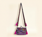 Close-up of Gulabi Aag cowrie shell & tassel detail