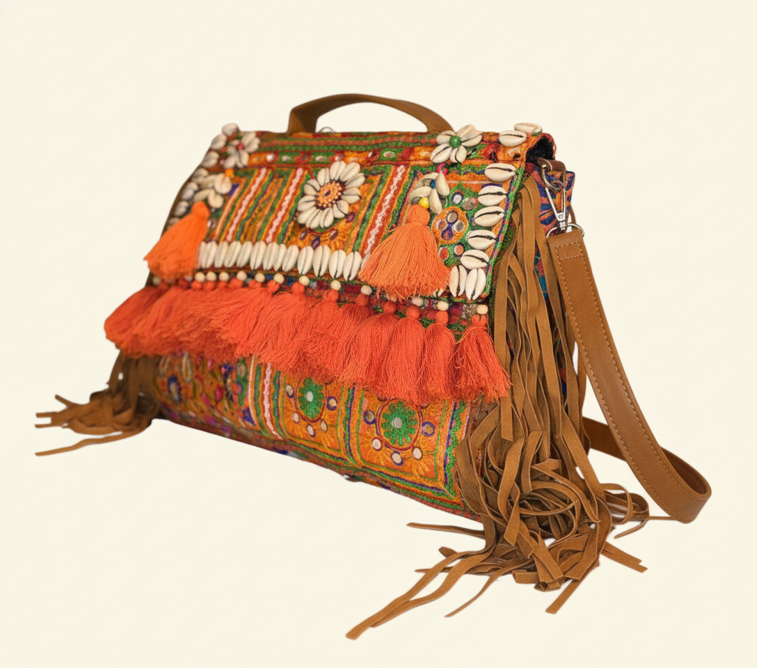 Model walking with Shell Tassel Kesari crossbody bag — lifestyle shot