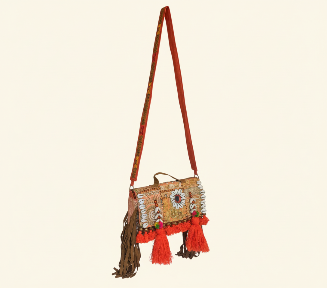 Model walking with Shell Tassel Narangi crossbody bag — lifestyle shot