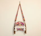 Model carrying Shell Tassel Dugdh crossbody bag — boho style