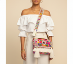 Model walking with Shell Tassel Dugdh crossbody bag — lifestyle shot