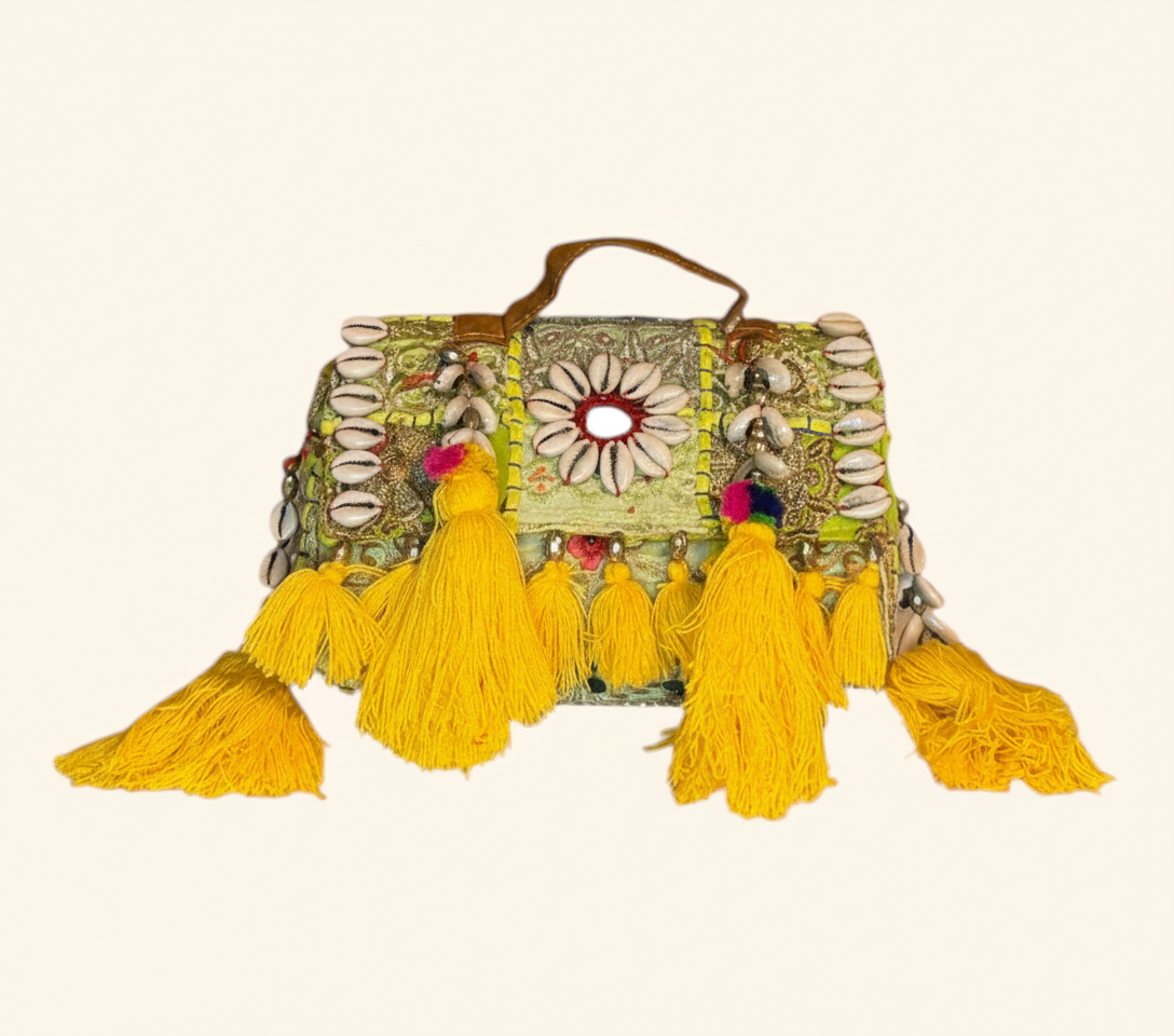 Model carrying Shell Tassel Pitambari crossbody bag — boho style