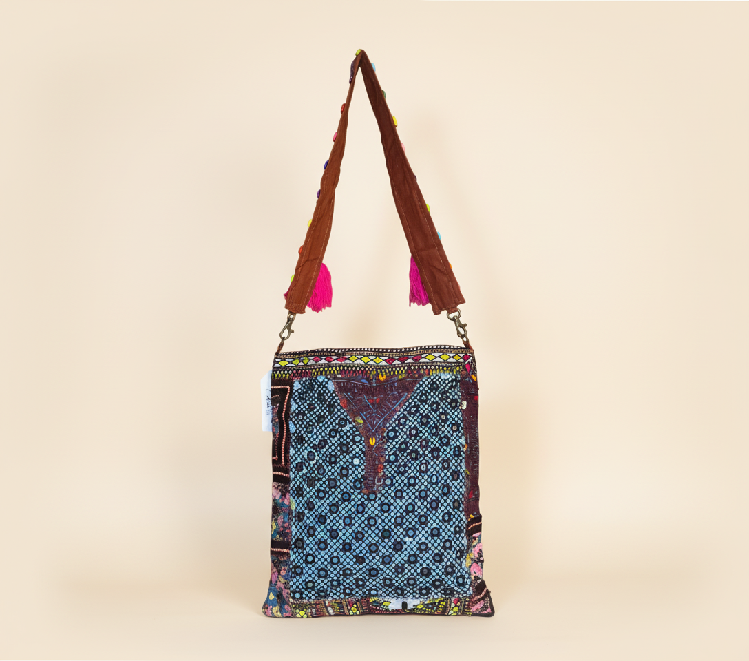 Model carrying Shell Tassel Indigo Festival sling bag — boho style