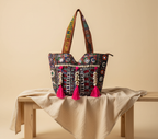 Model walking with Shell Tassel Ruby Tapestry tote bag — lifestyle shot