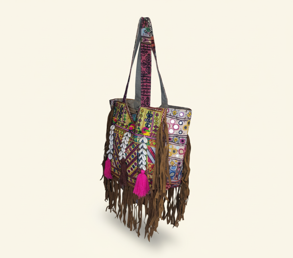 Close-up of Amber Fringe cowrie shell & tassel detail